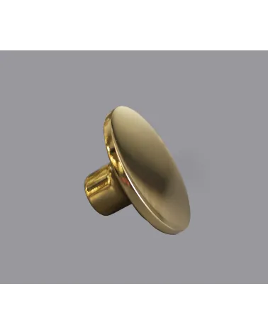 Polished brass ASTRO furniture knob designer handle on grey background