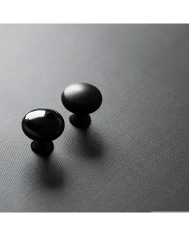 TORONTO furniture knob designer handle positioned diagonally on a dark surface