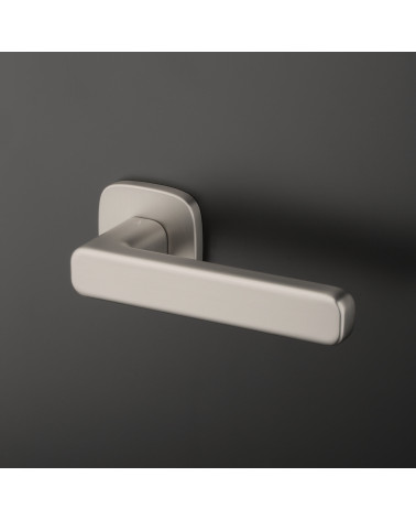 IXIA satin nickel door handle designer handle fixed on a dark background
