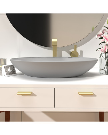 NOX-1 matte gold furniture handle designer pull mounted on a bathroom cabinet