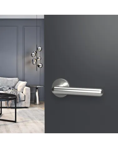 Polished chrome NOX door handle design hardware mounted on an open door