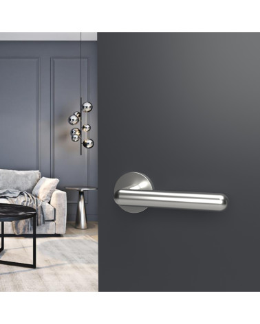 Polished chrome NOX door handle design hardware mounted on an open door