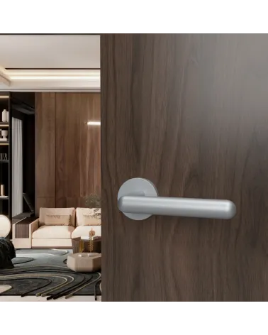 Satin chrome NOX door handle designer hardware mounted on an open door