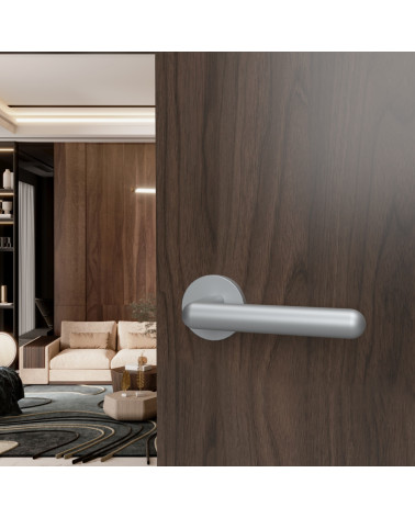 Satin chrome NOX door handle designer hardware mounted on an open door
