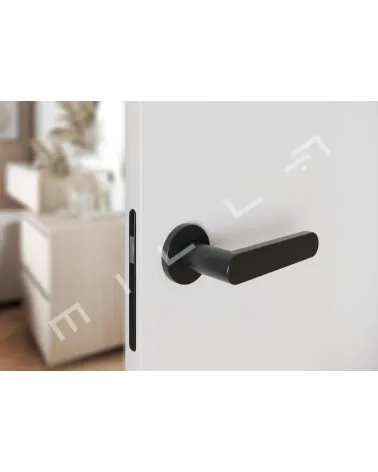 Black ALORA door handle designer handle tilted top view mounted on a door