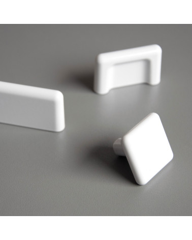 White furniture knob NOX design handle highlighted on a light surface