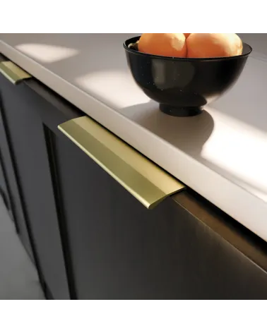 Gold anode furniture handle COSTA design handle close-up view mounted on a cabinet