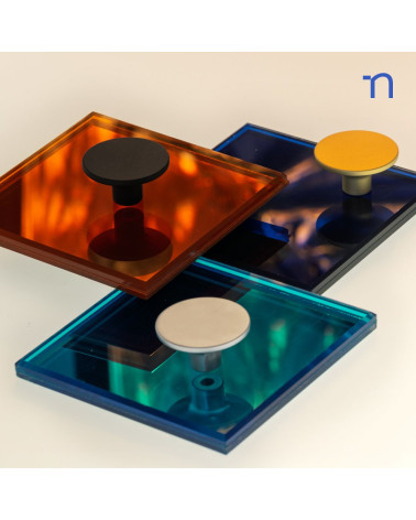 ASTRO furniture knob design handle presented on reflective plates