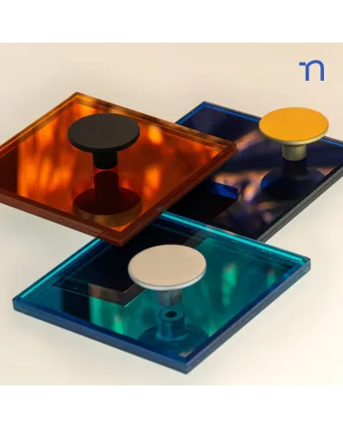 ASTRO furniture knob designer handle presented on reflective panels