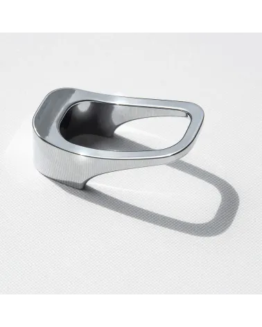 Polished chrome LAGO furniture knob designer handle laid on a white surface