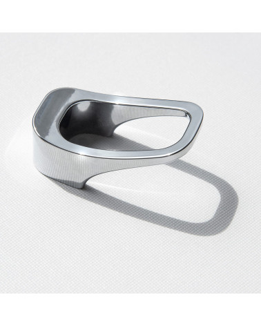 Polished chrome LAGO furniture knob designer handle laid on a white surface