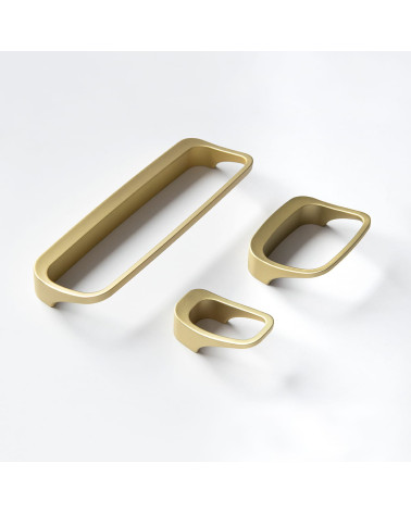 LAGO matt gold furniture knob designer handle arranged on a white surface