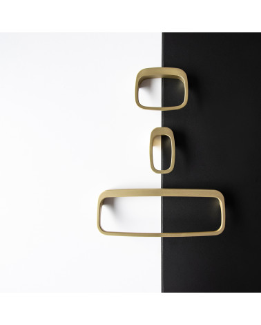 LAGO matt gold furniture knob designer handle arranged on a two-tone background